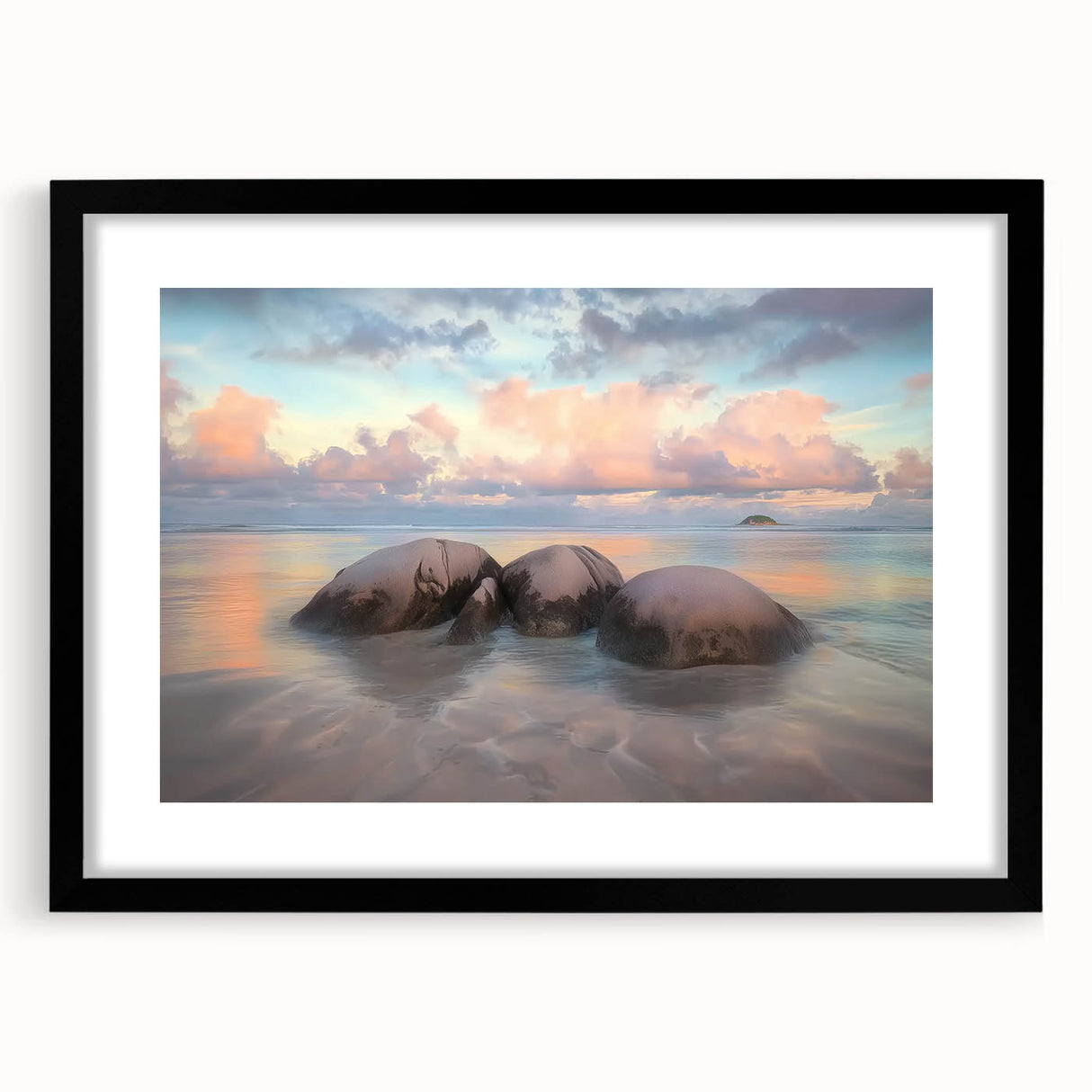 Black-framed landscape wall art depicting serene beaches with a mat, showcasing vibrant colors and intricate details, ideal for home decor enhancement.