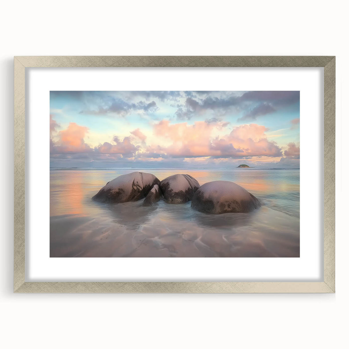 Landscape artwork featuring a serene beach scene framed in a sleek silver mat, showcasing gentle waves and a clear blue sky, perfect for coastal home decor.