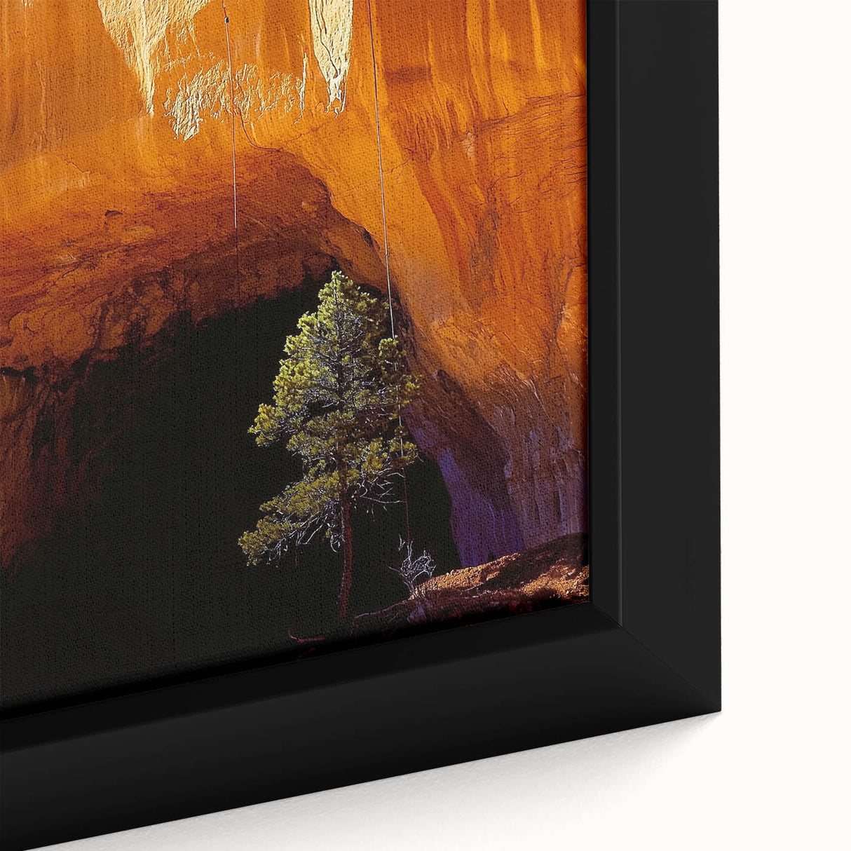 Close-up of a framed canvas artwork depicting a vibrant landscape with detailed cave formations, featuring earthy tones and intricate textures, ideal for home decor.