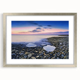 Landscape print of a serene beach scene framed in a sleek silver frame with a white mat, ideal for home decor and enhancing coastal-themed interiors.