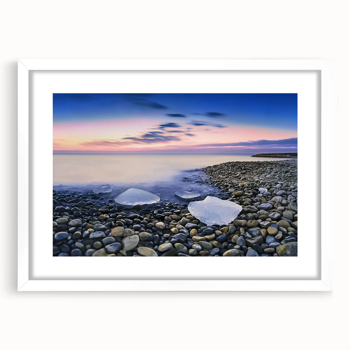 Framed landscape artwork depicting serene beaches with soft waves, featuring a white mat and sleek black frame, perfect for coastal home decor.