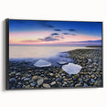 Framed canvas artwork depicting a serene beach landscape in vibrant colors, showcasing gentle waves and palm trees, presented in a sleek black frame for modern decor.