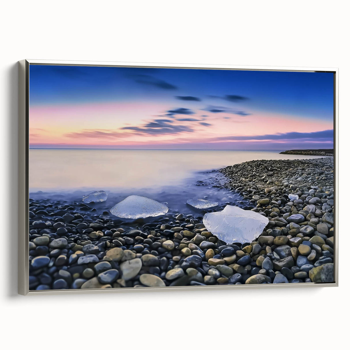 Framed canvas artwork depicting a serene beach landscape, showcasing vibrant blues and sandy hues with a sleek silver frame, ideal for coastal home decor.
