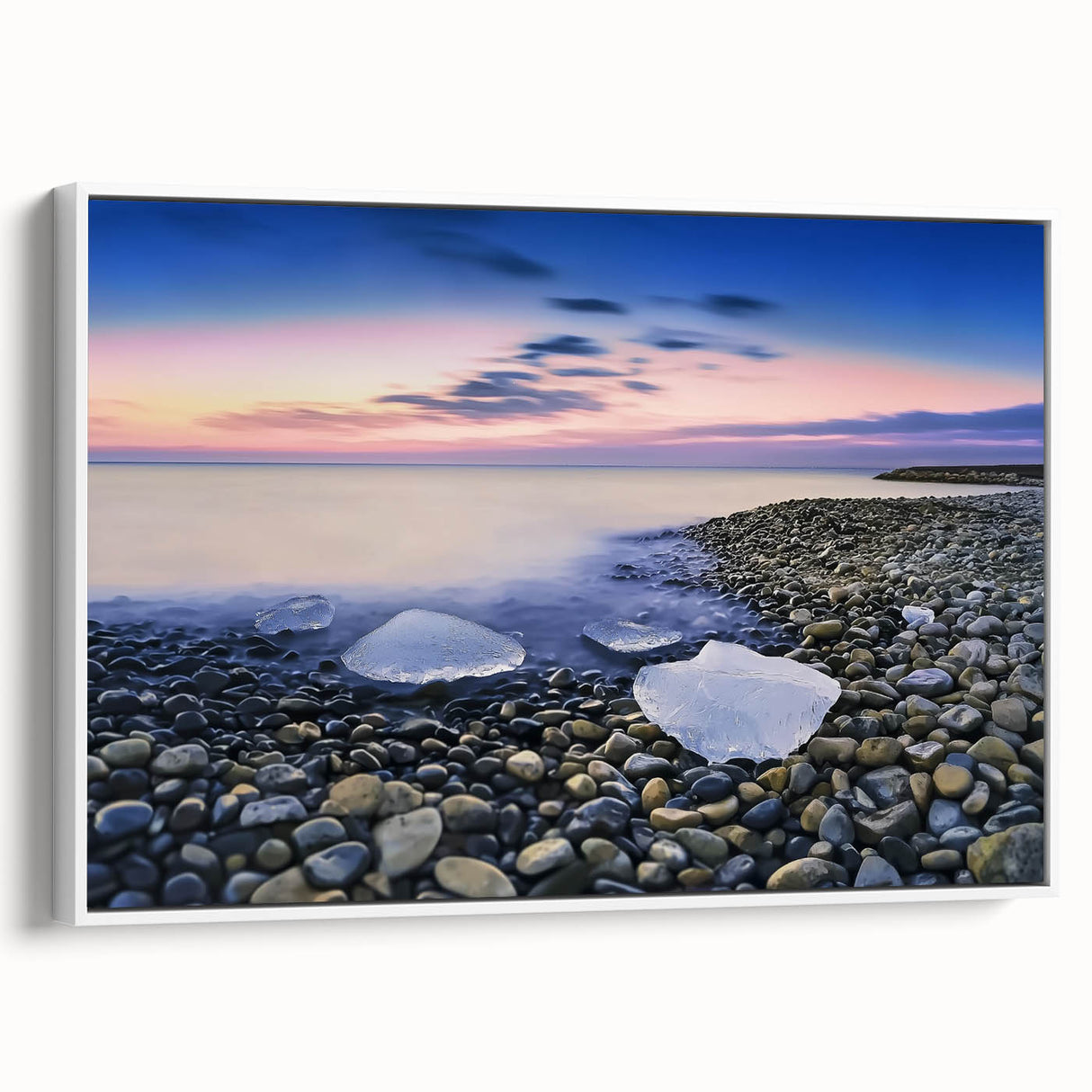 Framed canvas artwork depicting a serene beach landscape with vibrant colors, showcasing gentle waves and a clear sky, presented in a sleek white frame.