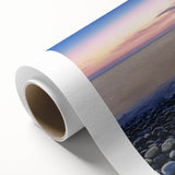 Vibrant rolled canvas artwork showcasing a serene beach landscape, featuring soft blue waves and golden sands, elegantly packaged in a protective cardboard tube.
