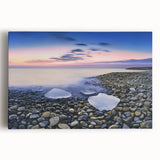 Stretched canvas artwork depicting a serene beach landscape with soft waves and a vibrant sunset, perfect for coastal home decor and relaxation themes.