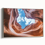 Framed canvas artwork of a vibrant canyon landscape, showcasing rich earthy tones and intricate details, elegantly displayed on a silver frame for modern decor.