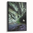 Framed canvas artwork depicting a serene cave landscape with rich textures and deep colors, showcasing a black frame from a side view, ideal for home decor.