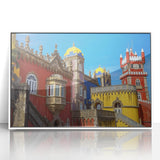 Framed acrylic artwork depicting a serene landscape with a majestic castle set against a vibrant blue sky, showcasing intricate details and vivid colors. This piece adds a touch of elegance to any home décor.