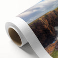 Stunning rolled canvas art print showcasing a dramatic landscape of cliffs, featuring vibrant colors and intricate details, elegantly packaged for display.