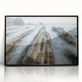 Framed acrylic artwork depicting a serene beach landscape with gentle waves and a clear blue sky, presented in a sleek black frame for elegant home decor.