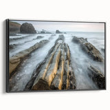 Framed landscape canvas print depicting a serene beach scene with gentle waves, vibrant blue skies, and lush palm trees, showcasing a sleek black frame side view.