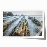Stunning landscape canvas print showcasing a serene beach scene with gentle waves and a clear blue sky, rolled and ready for display in a protective cardboard tube.