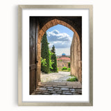 Framed landscape artwork depicting a majestic castle surrounded by lush greenery, featuring a silver matting that enhances its elegance, perfect for home decor.