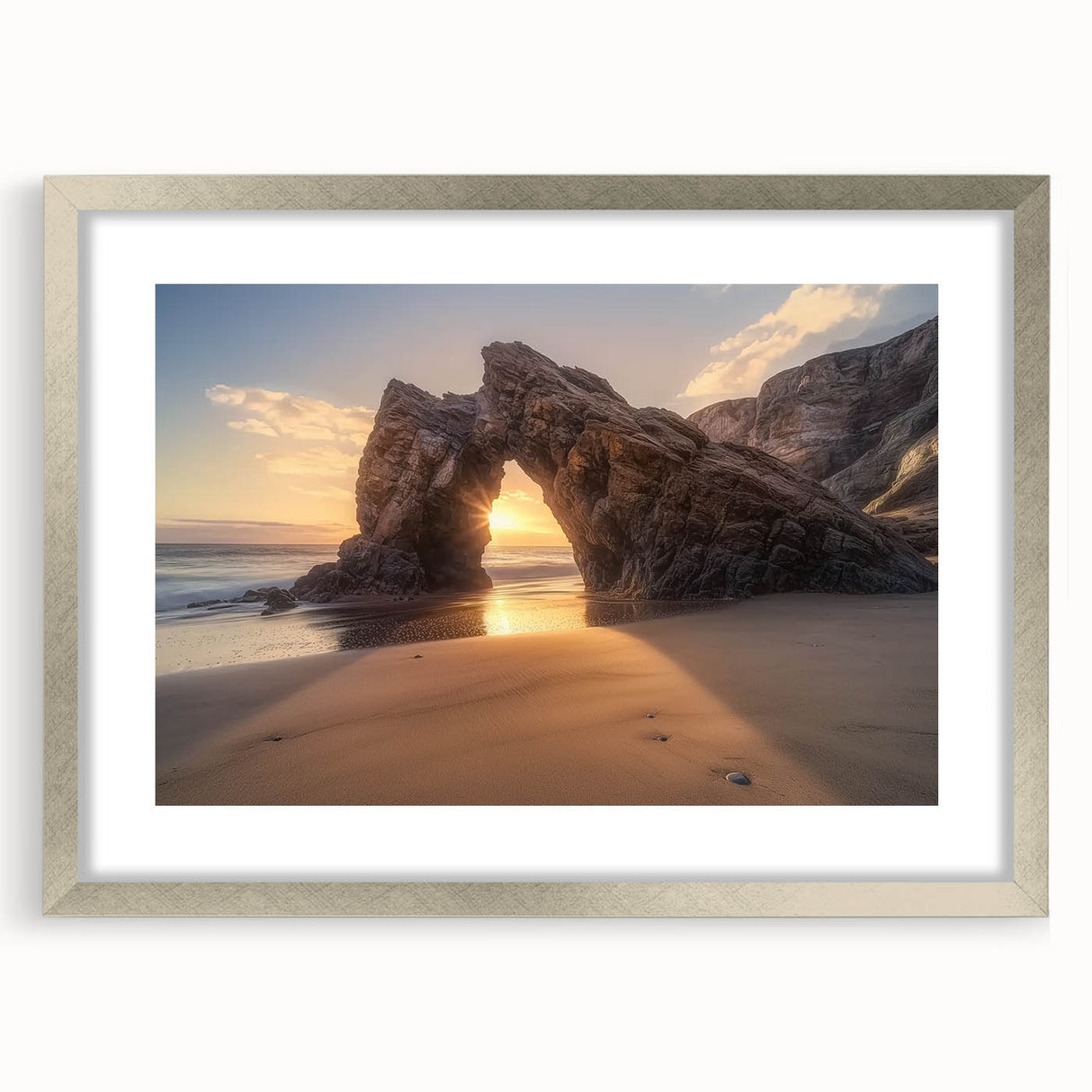 Framed landscape artwork depicting serene beaches with a silver mat border, showcasing soft blue and sandy tones, perfect for beach-themed decor.