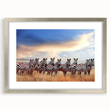 Textured abstract art print of an African landscape in muted earth tones on a framed canvas, suitable for bedroom decor.