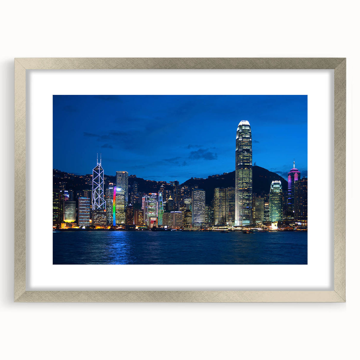 Textured art depicting an abstract Hong Kong skyline in muted gray tones, displayed in a silver frame with mat.