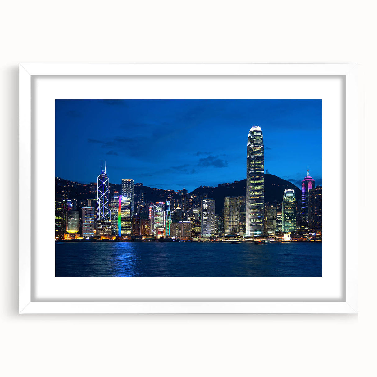 Abstract art print of Hong Kong skyline in muted gray and blue tones, framed with a white mat.