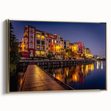 Vintage poster art of Queensland scenery on a framed canvas, featuring a gold frame and colorful imagery.