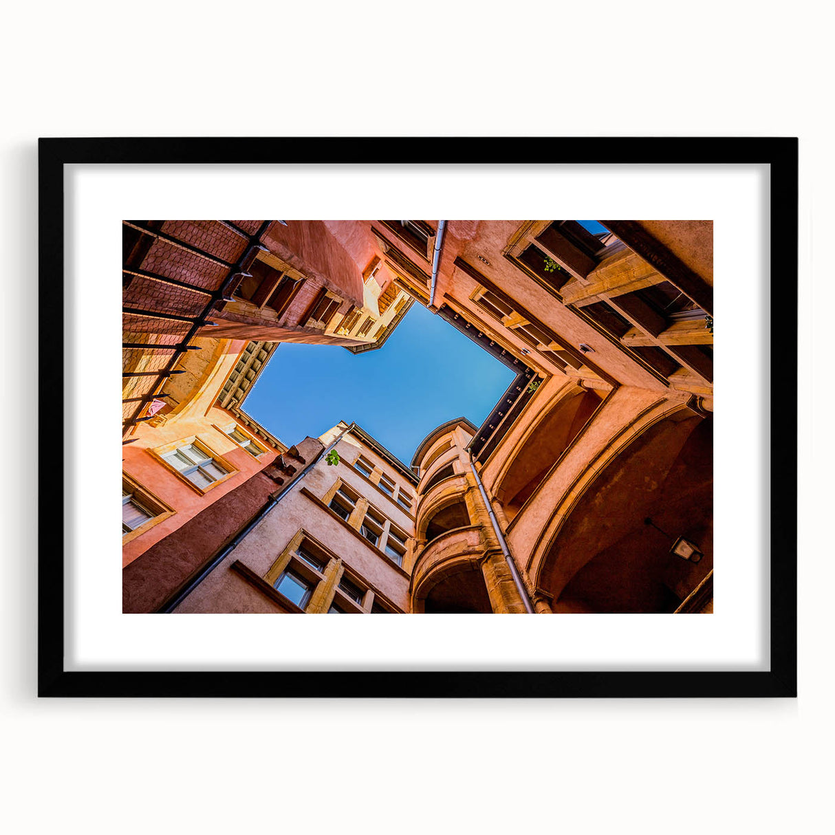 Extra large abstract art print of Lyon scenery in colorful, textured style on a black framed canvas.
