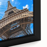 Black framed canvas of a textured Parisian street scene in colorful art style, ideal for living room decor.