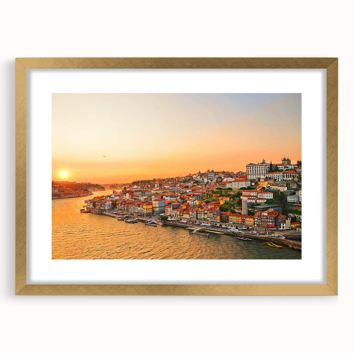 Textured art depicting abstract Porto scenery in muted gold and blue tones, framed with a gold mat, suitable for bedroom art.