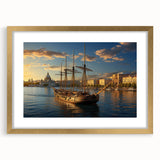 Abstract art print of a European cityscape in muted gold and blue tones, framed with a gold mat.