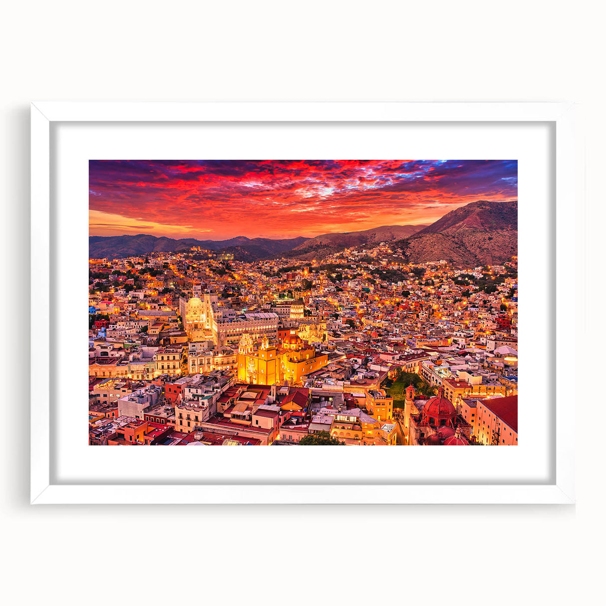 Abstract art print of Guanajuato, Mexico, featuring vibrant hues of orange and blue on a white framed canvas.