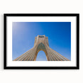 Abstract art print of a Middle Eastern scenery in vibrant colors on a textured, extra large canvas, framed in black.