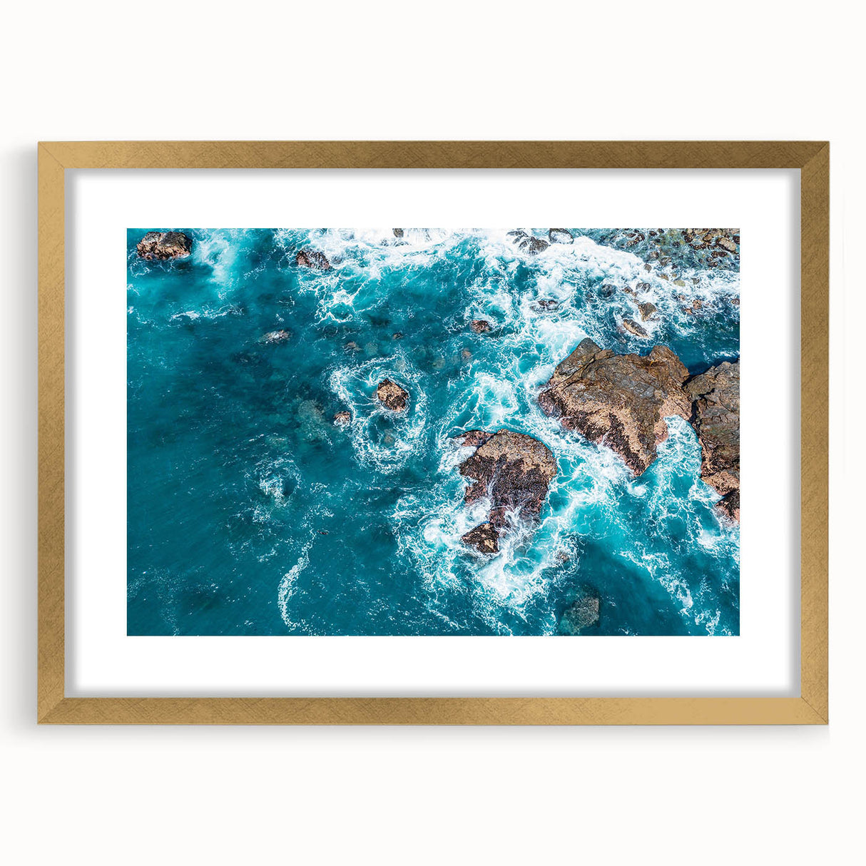 Extra large abstract art print of California's Big Sur in a gold frame, featuring textured blue and gray tones.