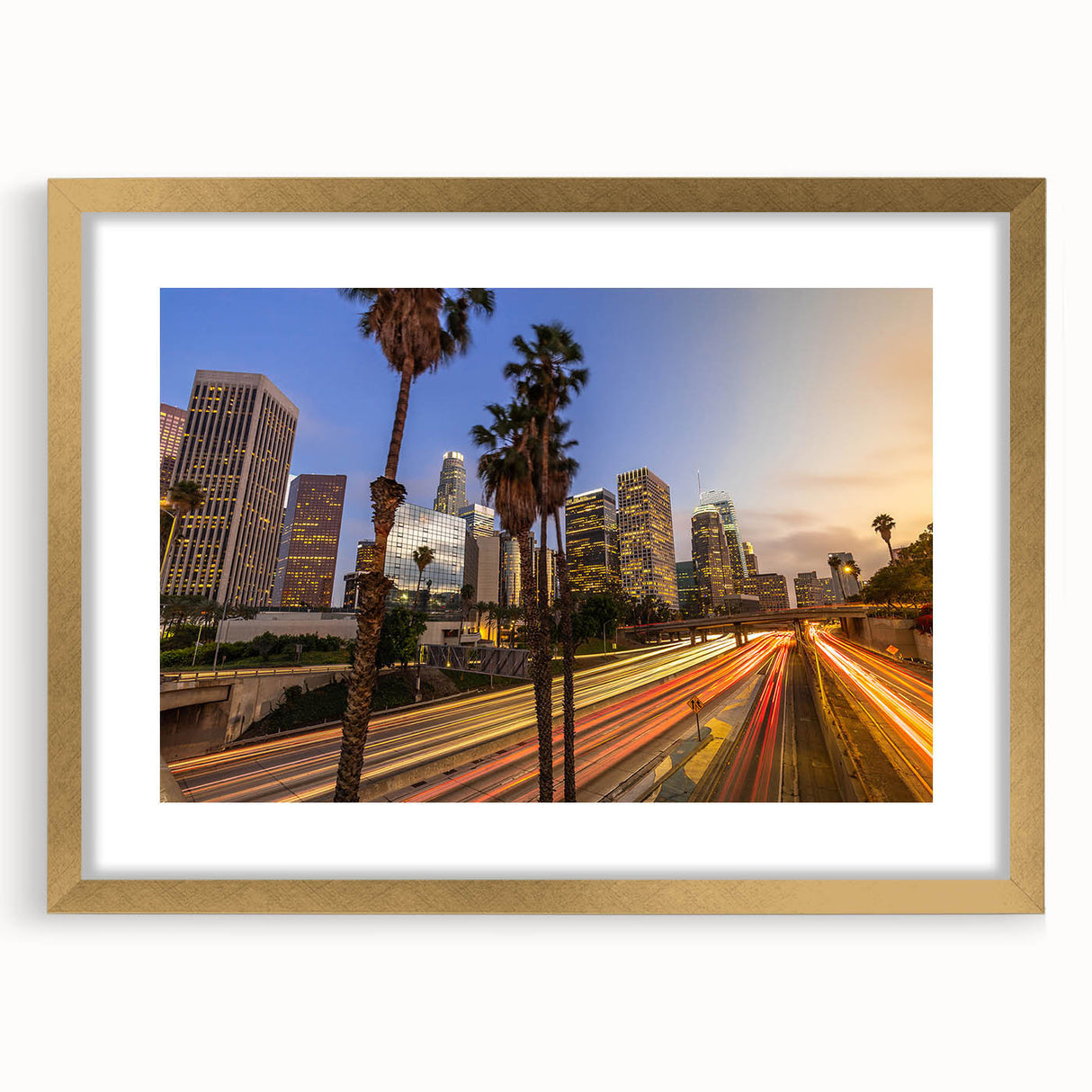 Extra large abstract art print of Los Angeles skyline in vibrant colors on a textured canvas, framed in gold.