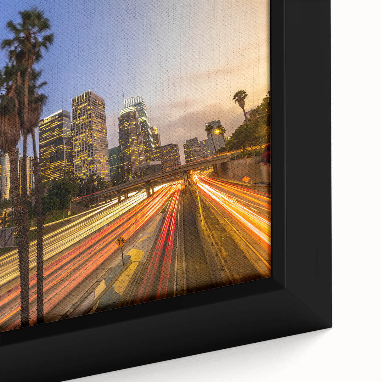 Black wall art depicting the Los Angeles skyline in vibrant colors on a textured, framed canvas.