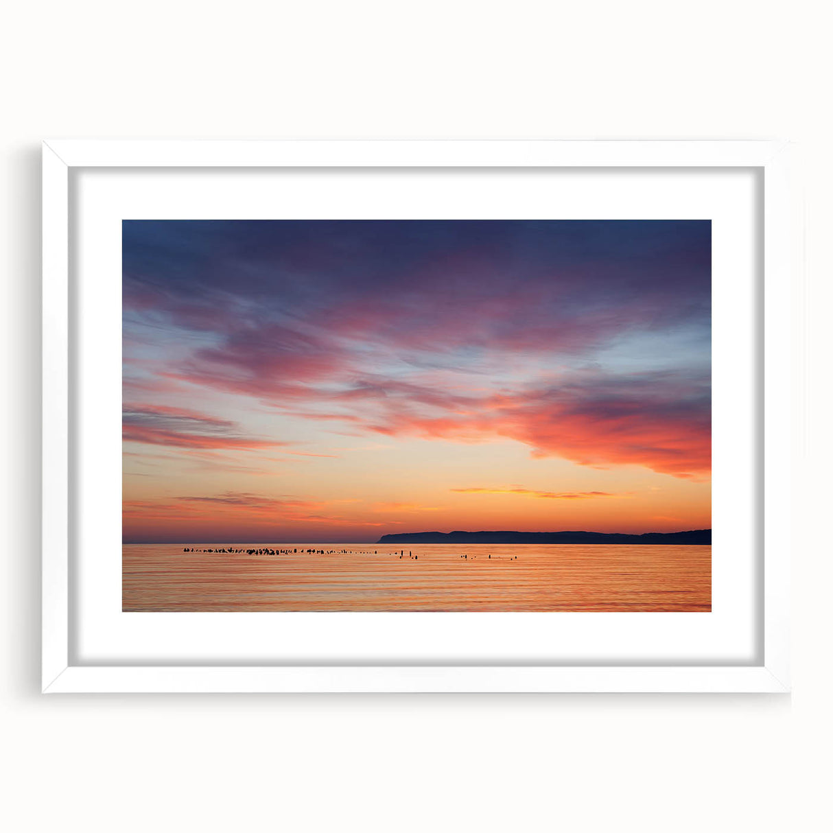 Abstract art print of Lake Michigan with muted blue and gray tones on a white framed poster, suitable for dining room decor.