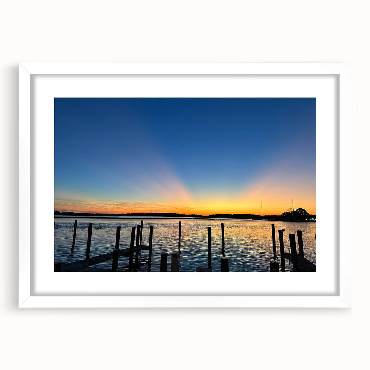 Abstract art print of Annapolis scenery in muted blues and greens on a framed white mat, ideal for dining room decor.