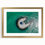 Extra large abstract art print of a textured seaside scene in muted blue and beige, framed in gold.