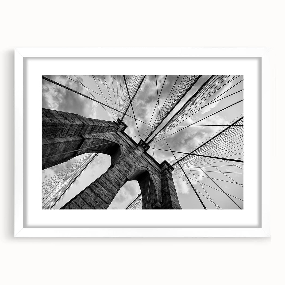 Abstract art print of Brooklyn Bridge in monochrome shades on a white matted frame.