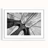Abstract art print of Brooklyn Bridge in monochrome shades on a white matted frame.