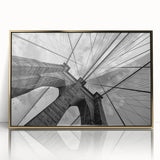 Acrylic print of the Brooklyn Bridge with a gold frame, featuring muted gray and blue tones, ideal for modern art wall decor.