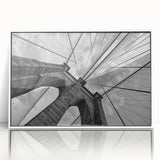 Acrylic print of Brooklyn Bridge in muted gray tones, framed in white, ideal for modern art wall decor.