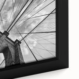 Framed canvas featuring a close-up, textured depiction of the Brooklyn Bridge in black with colorful accents.