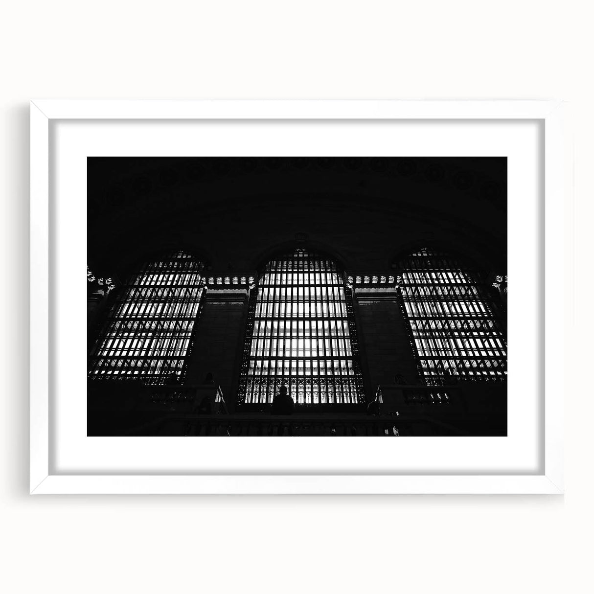 Abstract art print of New York City's Grand Central, in muted gray and blue tones, framed with white mat.