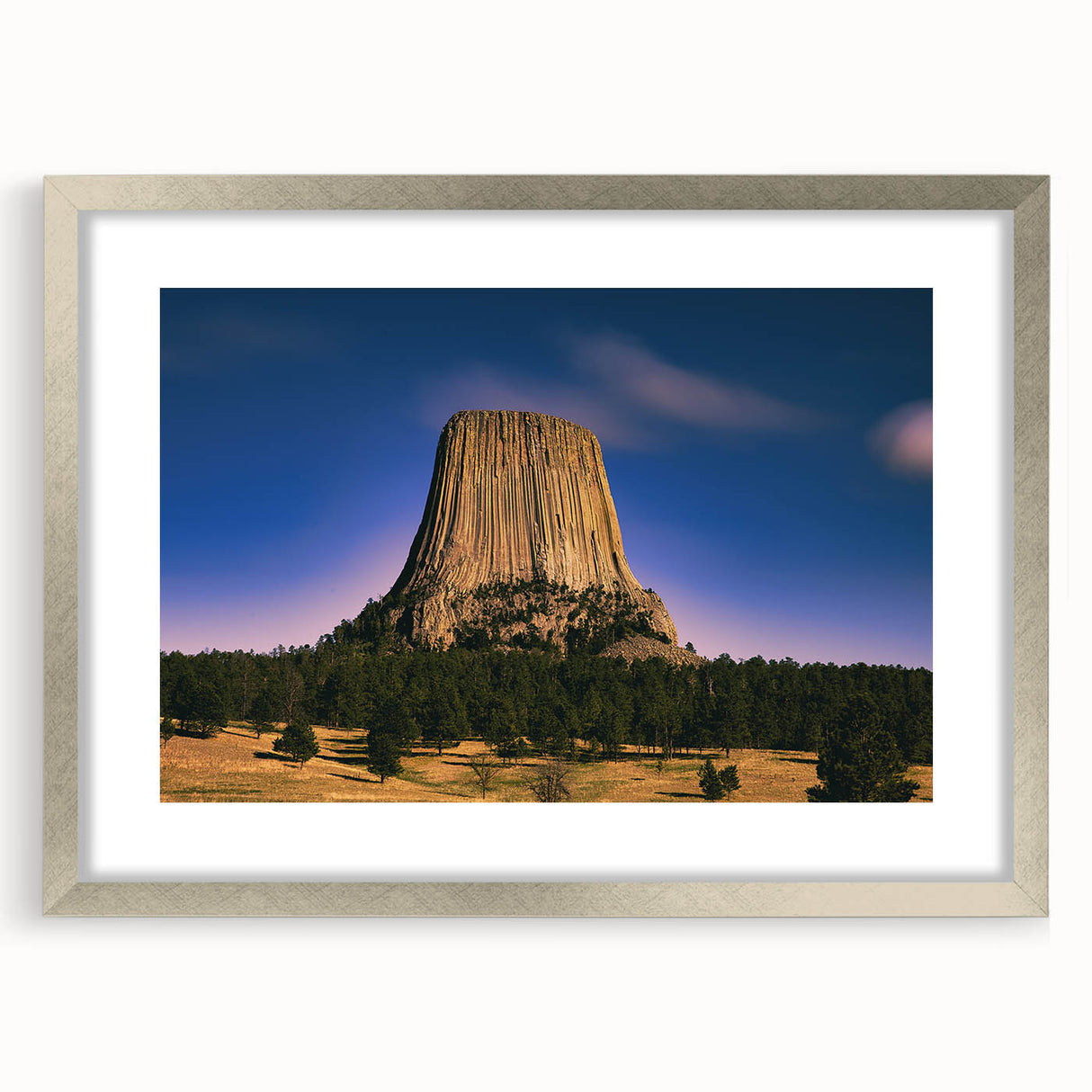 Textured art depicting abstract Badlands scenery in muted earth tones, framed in silver, ideal for bedroom art.