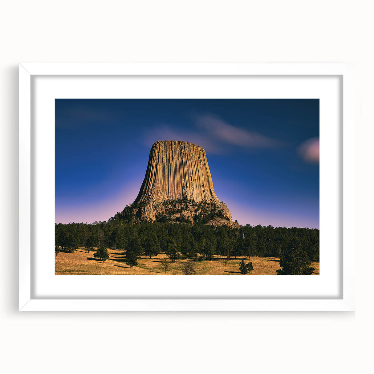 Abstract art print of South Dakota Badlands in muted earth tones on a framed white mat, suitable for dining room decor.