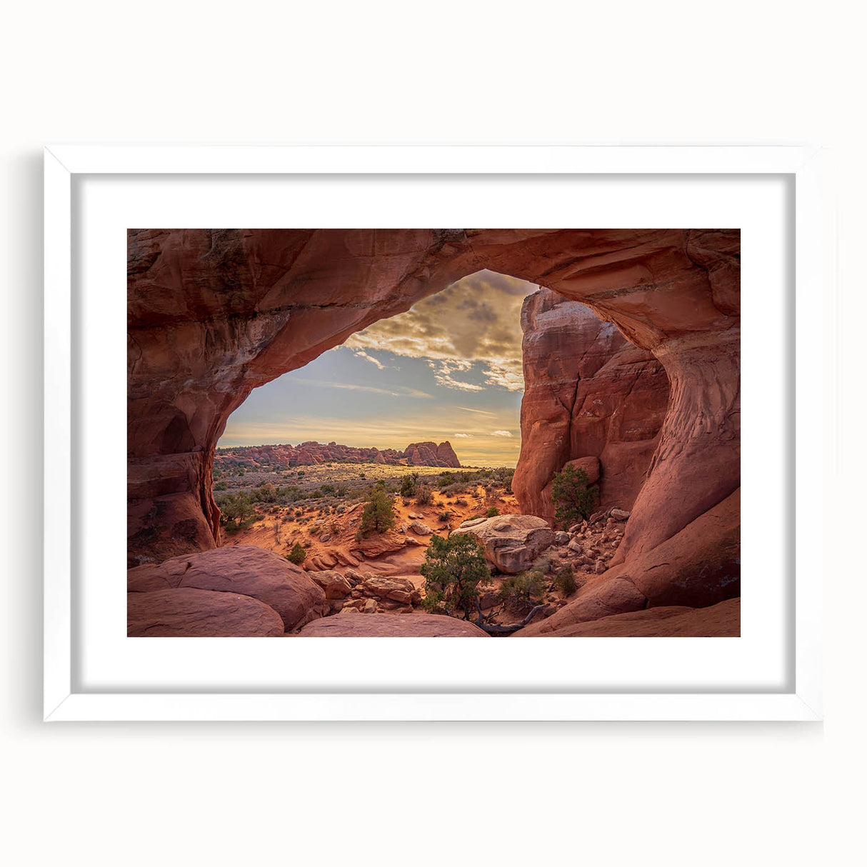 Abstract art print of Arches National Park in muted orange and red tones on a framed white canvas.