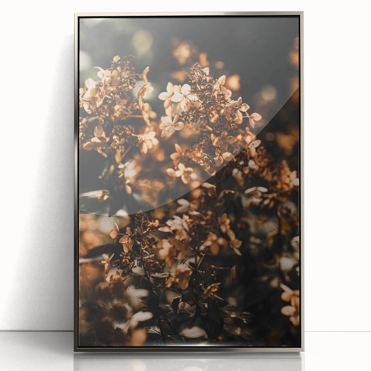 Mid-century modernist art featuring a fall landscape in warm orange and brown tones on a silver-framed acrylic print.