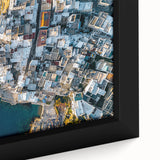 Close-up view of a framed canvas print depicting a vibrant landscape with dramatic cliffs, showcasing rich colors and intricate textures, perfect for home decor.