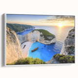 Framed landscape canvas artwork showcasing a serene beach scene with soft waves and a vibrant sunset, elegantly displayed with a white frame and side view perspective. Perfect for coastal decor enthusiasts seeking tranquility in their interior spaces.