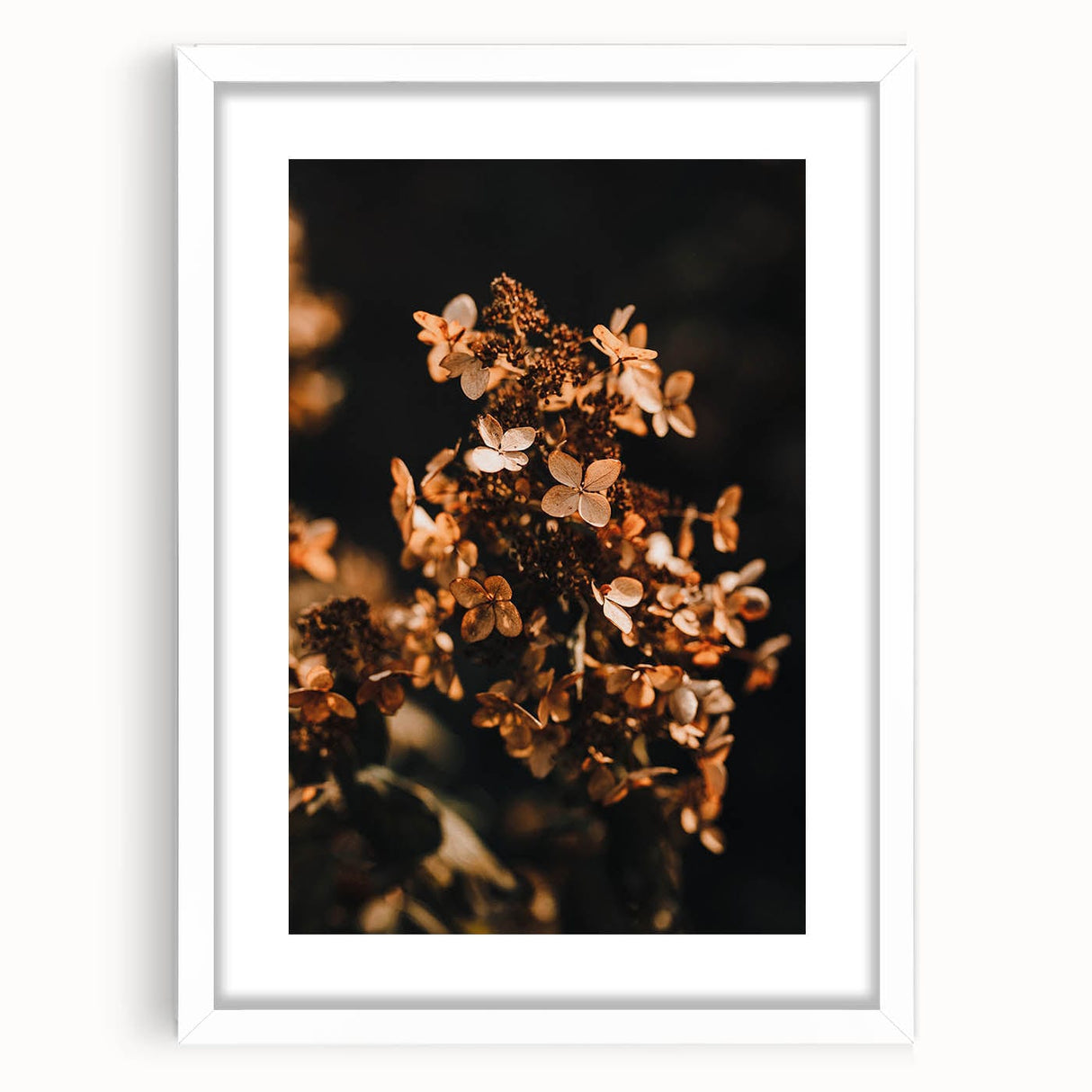Abstract art print depicting autumnal trees in warm orange and yellow tones on a white framed canvas.