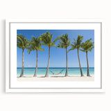Landscape artwork framed in white mat, depicting serene beach scene with soft waves and golden sand, perfect for coastal home decor.