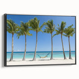 Framed landscape canvas art depicting serene beach scenery with vivid blue sky and golden sand, featuring a sleek black frame for elegant presentation.